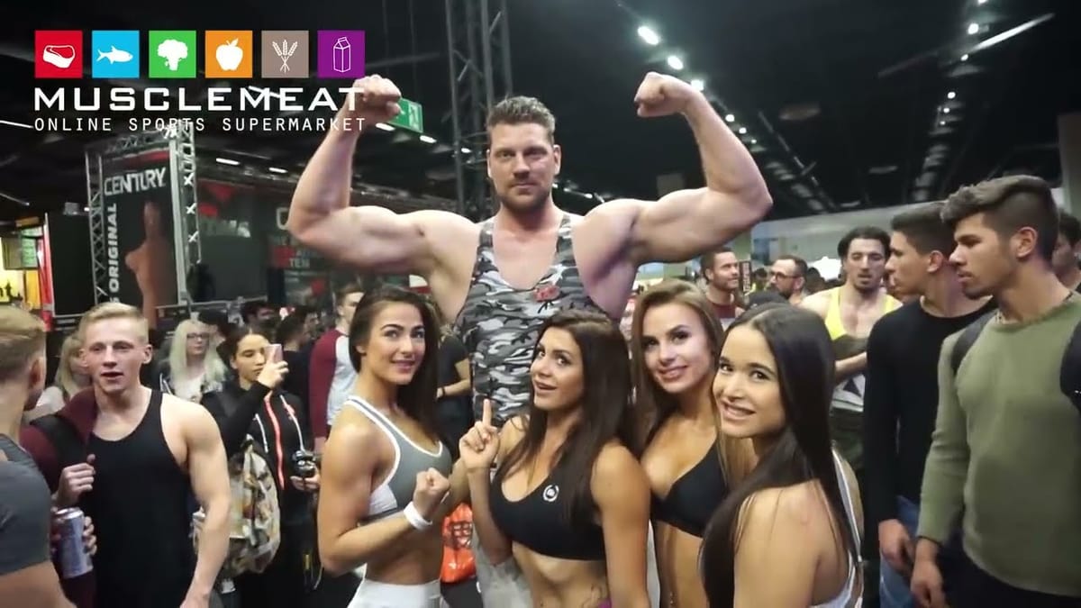 Olivier Richters flexing among visitors at the FIBO fitness fair in Cologne, 2017