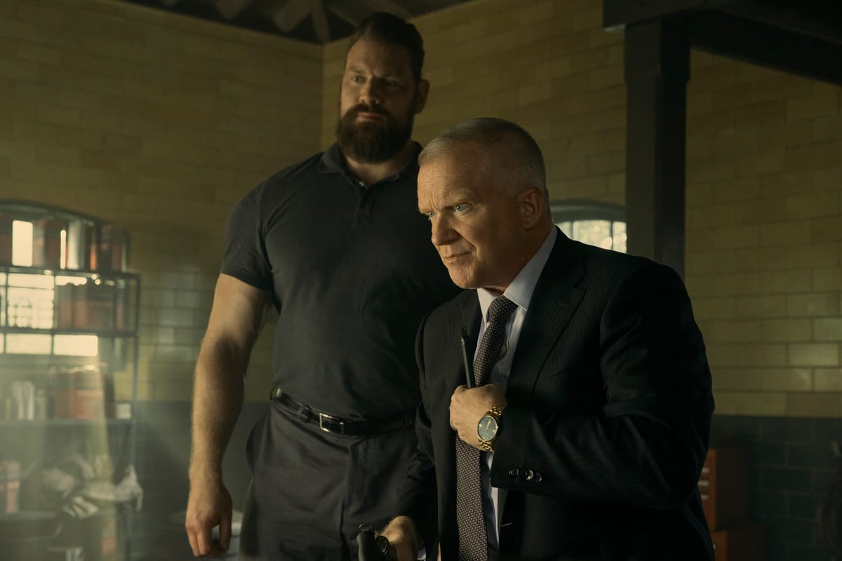 Reacher season 3: Paulie behind Zachary Beck, played by Anthony Michael Hall