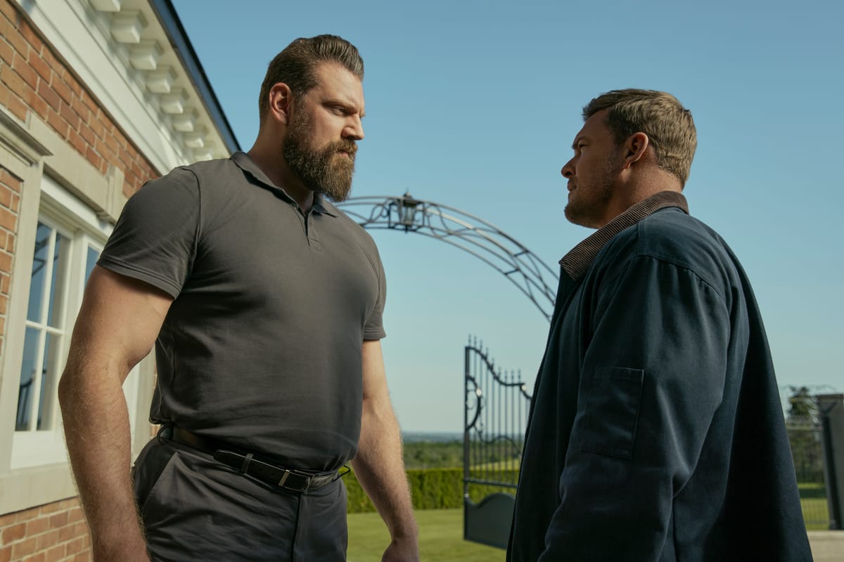 Reacher season 3: Olivier Richters as Paulie squares up to Alan Ritchson as Jack Reacher outside a country house