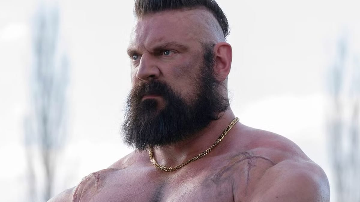 Olivier Richters as Zangief in Street Fighter (2026): mohawk, full beard, gold chain, scarred shoulders